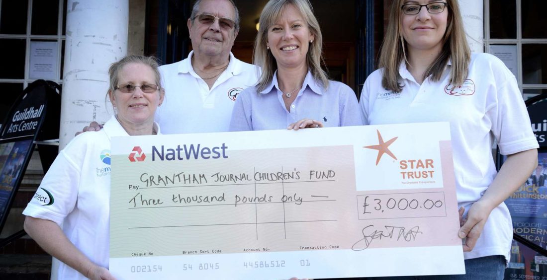 Grantham Journal Children's Fund receiving cheque