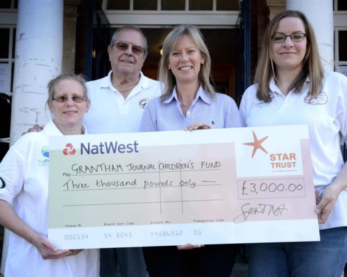 Grantham Journal Children's Fund receiving cheque